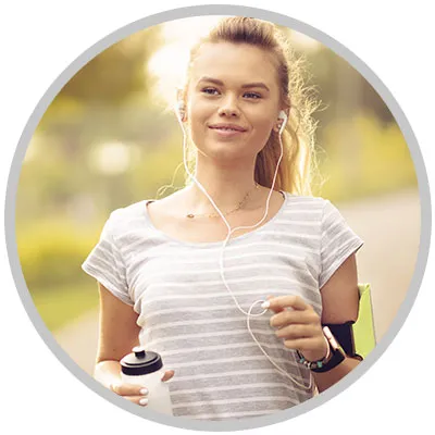 Woman running outdoors after improving asthma control.